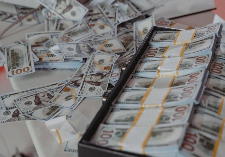 bundles of cash money in a black tray