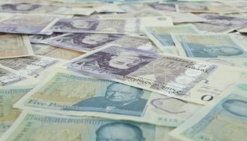 5 pieces of banknotes on yellow and white textile