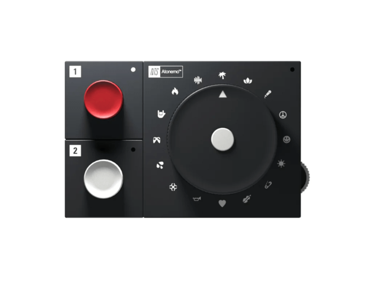 A photo of the NTS Radio Player. a black rectangular device with a dial, one red button and one white button.
